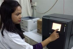 Lab technologist operating laboratory equipment