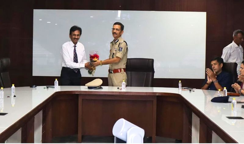 The Police Commissioner of Ahmedabad presenting a bouquet to Dr. Singhvi